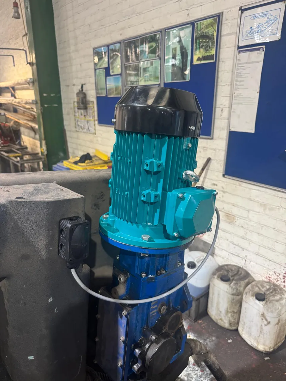After: turquoise replacement motor on the same blue gearbox